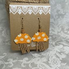 the earrings are made with beads and bead designs on them, along with lace doily