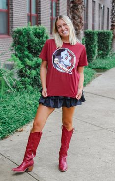 Get your game on with The Seminoles Sequin Shirt! This classic short sleeve tee features a relaxed fit, perfect for cheering on the 'Noles. The Sequin Seminole logo adds just the right amount of sparkle for game day. Score a style touchdown with this must-have tee! Details: *OFFICALLY LICENSED* Super Soft, & Stretchy Tee 100% Cotton Crew Neckline, Short Sleeve, Full Length Features Sequin Seminole Head Graphic on Center Chest Color: Garnet True to Size: Ladies Classic Fit Madison is wearing size X-Small Garment measurements in inches: X-Small = Bust: 17” / Length: 22” Small = Bust: 19” / Length: 23 1/2” Medium = Bust: 20” / Length: 24” Large = Bust: 20 1/2” / Length: 25” X- Large = Bust: 22” / Length: 25” Have questions about sizing, fit, or styling? Send us a chat or give us a call at 850 Cowgirl Style Outfits, Tallahassee Florida, Sequin Shirt, Fashion Bottoms, Florida State University, Florida State Seminoles, Auburn Tigers, African Braids Hairstyles, African Braids