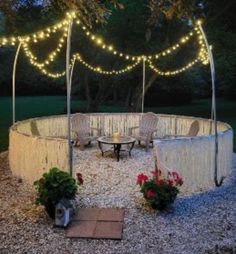 an outdoor seating area is lit up with fairy lights