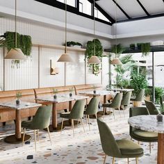 an empty restaurant with green chairs and plants hanging from the ceiling, along with white tile flooring