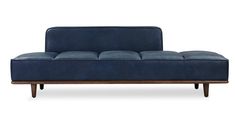 a blue couch sitting on top of a wooden frame