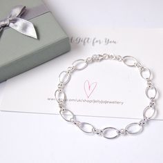 Silver Flat Oval Link Bracelet This Bracelet in Sterling Silver, it is approx. 19 cms. weighs just under 5gms and is hallmarked 925. A gorgeous on-trend bracelet, stylish, understated and bound to attract compliments. It is perfect on its own or for layering with dainty chains. Your purchase will arrive in a organza pouch or you could choose a luxury ribboned box, as illustrated from the drop down menu. I will send your purchase via Etsy Royal Mail, using regular post, if you prefer to have your White Gold Link Bracelet For Gift, Minimalist Sterling Silver Oval Bracelets, White Gold Link Bracelets As Gift, White Gold Bracelet With Sterling Silver Clasp For Gift, White Gold Oval Link Bracelet As A Gift, Silver Dainty Oval Link Bracelet, White Gold Link Bracelets For Gifts, Minimalist Sterling Silver Oval Bracelet, Minimalist Oval Sterling Silver Bracelets