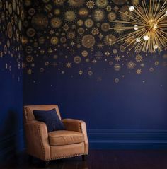 a brown chair sitting in front of a blue wall with snowflakes on it