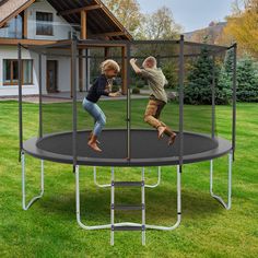 two children jumping on a trampoline in the yard