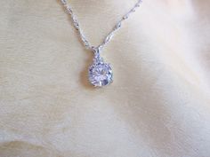 This 6.5 carat round brilliant Cz is accented with 3 small cz's and comes on a chain that  measures 18 inches in length and is .925 sterling.  The main stone is 9.5mm in width making this a great looking substitue for a more expensive stone. Expensive Stones, Cz Pendant, Round Brilliant Cut, Houston Tx, Round Brilliant, Pendant Necklaces, Jewelry Necklace Pendant, Houston, Jewelry Necklaces