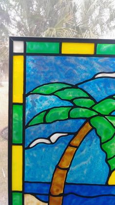 a stained glass window with a palm tree