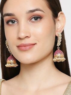 Gold-Toned and Pink Dome Shaped Earrings and has pearls Secured with a fish hook ear wire Size & Fit Earring Length - 8.5 cm, Width - 3.5 cm Material & Care Material: Alloy Stone Type: Pearls Dispatch within 7 days Ethnic Kurti, Anarkali Lehenga, Wedding Jumpsuit, Ready To Wear Saree, Indian Earrings, Jhumka Earrings, Dress Jewelry, Wedding Wear, Bollywood Fashion