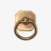 an antique brass plated towel ring on a white background