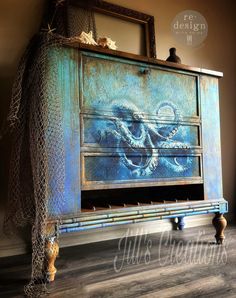 an old dresser with octopus artwork on it