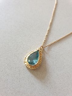 This 14k gold filled Blue Topaz necklace was designed in an antique style, with a bright Turquoise colored pendant in a teardrop shape. The gemstone birthstone necklace is handmade and delicate and available both in 14 karat gold filled and sterling silver. The Blue Topaz is lab made. Dimensions: Pendant height is 0.5 inches and it is 0.3 inches wide. This pendant necklace is available in multiple lengths. Please choose on checkout. The Blue necklace is a great birthstone necklace for mom and th Antique Coin Necklace, Necklace Gold Pendant, December Birthstone Necklace, Gold Topaz, Gold Coin Necklace, Blue Topaz Necklace, Bright Turquoise, Topaz Necklace, Blue Topaz Earrings