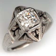 an antique style diamond ring with filigrees