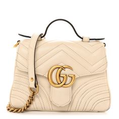 This is an authentic GUCCI Calfskin Matelasse Mini GG Marmont Top Handle Shoulder Bag in White. This shoulder bag is crafted of smooth & supple calfskin leather in white. This bag features a leather handle, and a long aged gold chain shoulder strap with a leather shoulder pad. The front crossover flap opens to a beige microfiber interior with a patch pocket. Gg Marmont, White Bag, Leather Handle, Shoulder Pads, Crossover, Gold Chain, Top Handle, Patch Pocket, Gold Chains