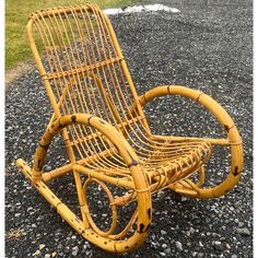 a yellow rocking chair sitting on top of gravel