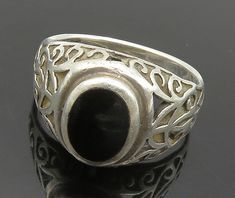 925 Sterling Silver - Vintage Inlaid Black Onyx Swirl Band Ring Sz 6 - RG15742  925 Sterling Silver - Vintage Inlaid Black Onyx Swirl Band Ring Sz 6 - RG15742  Jewelry Type:         Ring  Metal Type:            925 Silver   Metal Size:             6 Finger  Stone Type:            Onyx   Condition:              N/A  Jewelry Weight:     3.4 Grams  PLEASE NOTE: THIS ITEM IS PRE-OWNED. ALTHOUGH MOST ITEMS ARE IN VERY GOOD CONDITION, SOME MAY NEED CLEANING AND/OR MINOR REPAIRS. WE MAKE A VERY STRONG EFFORT TO UPLOAD CLEAR PICTURES. PLEASE INSPECT ALL PICTURES AND ASK ALL QUESTIONS YOU MAY HAVE PRIOR TO MAKING A PURCHASE. NOT ALL STONES ARE GENUINE, SOME ARE ENHANCED OR CREATED. Black Filigree Ring, Black Oval Rings With Intricate Design, Black Oval Ring With Intricate Design, Black Filigree Ring Jewelry, Classic Black Filigree Rings, Ornate Black Sterling Silver Rings, Ornate Black Oval Ring, Black Oval Filigree Ring, Black Filigree Ring With Intricate Design