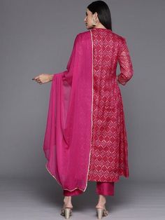 Grab this beautiful 3-piece set. The set comes with bandhani print & zari embroidery anarkali kurta has mandarin collar, 3/4th sleeves & calf length teamed with solid trouser pant with elasticated waistband & slip-on closure and a silk chiffon dupatta with lace detailing. Color - Pink Kurta Fabric-Cotton Blend Bottom Fabric-Silk Blend Dupatta Fabric - Silk Chiffon Neck-Mandarin Colar Sleeves-3/4th Sleeves Work - Bandhani Print & Zari Embroidery Washing Instructions-Hand Wash DISCLAIMER - The color of the product may be differ due to screen settings of device. A misprint here and a color drop slip there is the beauty of printing which is not treated as a defect. Festive Bandhani Print Straight Kurta Anarkali Set, Festive Anarkali Set With Bandhani Print For Diwali, Designer Bandhani Print Palazzo Set For Navratri, Eid Designer Palazzo Set With Bandhani Print, Eid Bandhani Print Palazzo Set For Designer Wear, Bandhani Print Dupatta For Diwali, Diwali Georgette Sets With Dupatta, Diwali Bandhani Print Palazzo Set With Straight Kurta, Unstitched Bandhani Print Anarkali Set For Festive Season