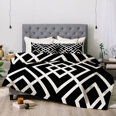 a bed with black and white comforters on it