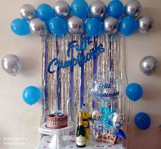 a table topped with a cake and balloons