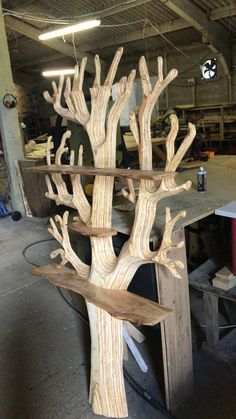 a wooden tree is sitting in the middle of a workshop