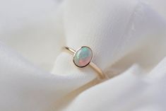 *This listing is for one Odette ring with a natural Ethiopian opal, in solid 14K gold of your choice. Meet our new Odette ring, featuring a otherworldly natural Ethiopian opal encased in a bezel setting on a fine delicate band, in solid 14K gold of your choice. Specifications: - Solid 14K gold of your choice (choose from dropbox) - Natural Ethiopian opal, approximately 1.3 - 1.5 carat - 1.8mm half round band - Handmade to order, please allow 5-7 weeks for us to craft your ring for you - Also ava 14k Gold Opal Ring With Bezel Setting, Antique Opal Ring, Opal Band, Handmade Jewelry Ring, Big Diamond, Bezel Ring, Opal Ring, Handmade Jewellery, Gold Platinum