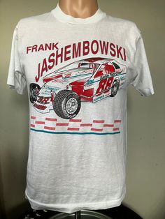 "True vintage late 80's/early 90's Frank Jashembowski DIRT Modified t-shirt. Size medium single stitched tee, excellent shape, no holes or stains. Measures 18\" pit to pit, 22\" collar to bottom." Throwback Short Sleeve Pre-shrunk T-shirt, Throwback Short Sleeve Fan Merchandise T-shirt, Throwback Fan Merchandise T-shirt With Short Sleeves, White Pre-shrunk Throwback T-shirt, White Throwback T-shirt, Shrink-resistant, Nostalgic Crew Neck T-shirt With Graphic Print, Nostalgic Crew Neck Pre-shrunk T-shirt, Retro Short Sleeve T-shirt With Vintage Print, Throwback Crew Neck Pre-shrunk T-shirt