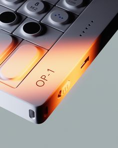 a close up view of an electronic device with buttons on the keyboard and light coming from it