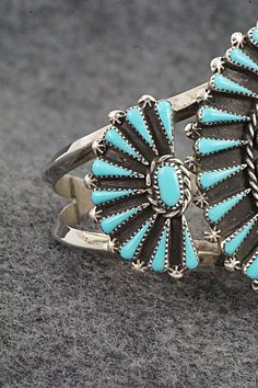 This turquoise and sterling silver bracelet was made by Zuni silversmith Carlos Tsipa. The inside of the cuff is signed C. Tspia.Size: 5 5/8" (will fit up to a 6 1/2" wrist)Gap: 7/8"Width: 2"Free shipping on all orders! We ship with USPS and always include tracking. All orders ship within a day of payment.Returns are accepted up to 30 days after you receive your order. Just send us a message. Our shop offers cash back or store credit. The item must be returned in new condition. Turquoise Sterling Silver Cuff Bracelet With Inlay, Sterling Silver Turquoise Cuff Bracelet With Inlay, Southwestern Sterling Silver Cuff Bracelet In Blue, Southwestern Blue Cuff Bracelet Stamped 925, Bear Carving, Pearl Chain, American Jewelry, Sterling Silver Bracelet, Native American Jewelry