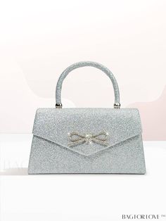 BagForLove - Silver Glitter Bow Top Handle Evening Bag - Elegant Satchel for Wedding Party Product Description Color Silver Details Rhinestone Magnetic Yes Strap Type Top Handle Pattern Type Plain Bag Size Small Closure Type Magnet Type Square Bag Material Glitter Composition 100% Polyester Size Chart INCH CM Bag Height Bag Length Bag Width Handle Height Strap Length 5.1 inch 9.1 inch 2.4 inch 3.5 inch 47.2 inch Bag Height Bag Length Bag Width Handle Height Strap Length 13 cm 23 cm 6 cm 9 cm 120 cm Details Pictures Similar Products h2 { text-align: center; } /* æ¢è¡ */ li{ white-space: normal; word-break: break-all; word-wrap: break-word; } .red-box { width: 100%; display: flex; flex-direction: row; flex-wrap: wrap; justify-content: center; } .red-box > div { width: 190px; height: 250px; Glamorous Silver Glitter Clutch, Chic Glitter Bags For Events, Glamorous Evening Clutch With Glitter, Glamorous Glitter Clutch For Evening, Party Handheld Bags With Rhinestones, Glitter Clutch Evening Bag For Event, Glitter Clutch Evening Bag For Events, Chic Sparkling Evening Bag For Party, Glitter Clutch Evening Bag Gift