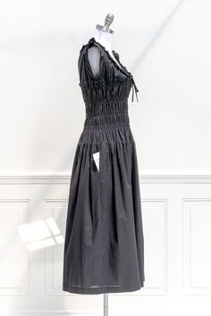 This lovely black midi dress in 100% cotton features a round neckline accented with lace and flutter shoulders, side-seam pockets, a generously smocked bodice with unique drop waist, and a tea-length skirt. . Details: Small: Bust 34"-40", Waist 26"-40", Length 48" Medium: Bust 36"-42", Waist 28"-42", Length 49" Large: Bust 38"-44", Waist 30"-44", Length 50" Length Measured from Shoulder Lined Side-Seam Pockets Material: 100% Cotton Imported Ships in 1 to 2 Business Days Free U.S. Shipping on Ord Dresses Cottagecore, Tea Length Skirt, Skirt Details, French Girl Style, Days Gone, Fall Dress, Black Midi, French Girl, Tea Length