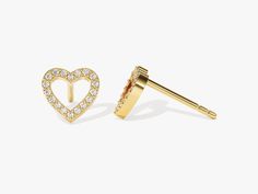 two pairs of heart shaped studs with diamonds on the side and an arrow in the middle