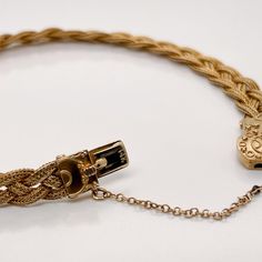 A very fine 14k gold Etruscan style bracelet.  With three delicate strands of woven braided gold wire terminating in an Etruscan style box clasp with granulated and wire work decoration.   Set with a safety chain.  Simply a finely-made Etruscan style bracelet!  Date: 20th Century  Overall Condition: It is in overall good, as-pictured, used estate condition with some very fine & light surface scratches and other signs of expected light wear consistent with age.  Fineness: Marked 14k for gold fine Elegant Braided Bracelet Jewelry, Elegant Braided Jewelry As Gift, Elegant Braided Jewelry For Gifts, Classic Braided Jewelry For Formal Occasions, Heirloom Gold Jewelry With Box Clasp, Elegant Braided Bracelets For Formal Occasions, Vintage Yellow Gold Multi-strand Jewelry, Heirloom Style Yellow Gold Jewelry With Box Clasp, Elegant Yellow Gold Bracelet With Wheat Chain