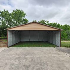 an empty garage in the middle of a field