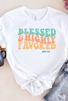 "My Description Our \"Blessed & highly favored\" shirt makes for a great gift. The comfortable fit and cool design of this shirt means that it feels just as good to wear as it is to look at. If you've been looking for an inspirational t-shirt for yourself, or your friend or family member, you should get this tee today. Bella + Canvas Brand Shirt ▶Unisex Adult Sizing ▶See Our Size Chart For Proper Sizing ▶Rolled sleeves are for styling purposes only ▶Props used in photos are not included with the Inspirational White Pre-shrunk T-shirt, White Graphic Tee With Lettering, White Graphic Tee Shirt With Lettering, Inspirational Letter Print White T-shirt, Inspirational White T-shirt With Letter Print, Inspirational Graphic Print T-shirt As Gift, Crew Neck T-shirt With Lettering For Gift, Inspirational White T-shirt For Gift, Inspirational White T-shirt As Gift