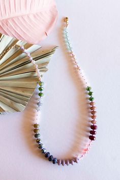 The Cece Colorful Beaded Necklace is a vibrant addition to any jewelry collection. This beautiful layering necklace features multicolor wood, crystal, and Pisa beads, creating a unique and eye-catching look. The handcrafted design ensures each piece is one of a kind, making it a perfect gift for anyone who loves to stand out from the crowd. This necklace is perfect for layering, adding a pop of color to your favorite outfits. The high-quality materials and attention to detail make this necklace Rainbow Beaded Necklaces With Wooden Beads As Gift, Rainbow Necklace With Round Wooden Beads, Rainbow Wooden Beads Round Necklaces, Rainbow Wooden Beads Necklace, Multicolor Multi-strand Crystal Necklaces With Faceted Beads, Colorful Beaded Necklace, Ombre Necklace, Rainbow Ombre, Necklace Collection