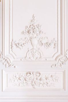 an ornate white paneled wall in a room