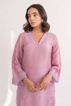 Onion pink kurta crafted in upada silk with flared sleeves and resham cutwork embroidery on the neckline, sleeves, front slits.
Components: 2
Pattern: Embroidered
Type Of Work: Resham
Neckline: V Neck
Sleeve Type: Flared
Fabric: Upada Silk
Color: Pink
Other Details: 
Length:
Kurta: 44 inches
Pant: 36 inches
Closure:
Pant: Elastic band in the back
Occasion: Puja - Aza Fashions Pink Tussar Silk Blouse Piece For Eid, Pink Silk Kurta With Chikankari Embroidery, Traditional Pink Chanderi Top, Festive Pink Straight Kurta Blouse, Designer Pink Tussar Silk Kurta, Unstitched Pink Slub Silk Blouse Piece, Pink Unstitched Slub Silk Blouse Piece, Pink Chikankari Embroidered Blouse For Eid, Pink Chanderi Blouse For Eid