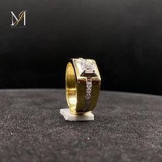 a close up of a gold ring with diamonds on the inside and in the outside