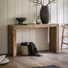 a wooden table with two vases on top of it