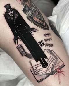 a man's arm with an image of a book and a clown on it