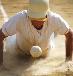 a baseball player sliding into the base during a game