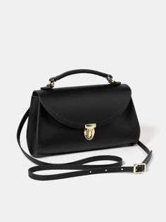 Poppy Mini Handbag - Black & Gold | Cambridge Satchel Timeless Top Handle Satchel With Fold Over Clasp, Classic Saddle Bag With Hasp Closure For Everyday Use, Timeless Everyday Satchel In Clutch Shape, Timeless Bag With Adjustable Handle, Timeless Everyday Bag With Adjustable Handle, Timeless Everyday Satchel Clutch, Timeless Bags With Adjustable Handle For Everyday, Elegant Small Evening Shoulder Bag, Classic Top Handle Flap Bag For Gift