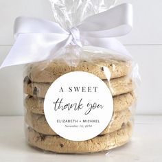 a bag of thank you cookies with a white ribbon