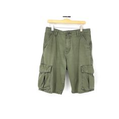 Here is a pair of vintage Levi cargo shorts.  Snap closures on the pockets. One uber tiny spot in the front on the right side by the groin.  Not noticeable.  There is only one tag on the inside.  The other tag looks to be ripped out.   Measurements Waist 34 in Hips 42 in Inseam 11.5 in Length 24.5 in Utility Cargo Shorts With Short Legs, Military Style Shorts For Outdoor With Pockets, Military Khaki Shorts With Pockets, Military Style Short Bottoms With Pockets, Military Style Shorts With Pockets, Short Military Cargo Pants With Pockets, Utility Bermuda Shorts With Pockets, Outdoor Cargo Shorts With Patch Pockets, Cargo Shorts With Patch Pockets For Outdoor