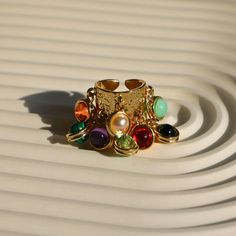 💎 Make a statement with our Gold Chunky Boho Ring! This thick band ring, with its multicolor gemstones and irregular design, is the perfect blend of baroque style and boho chic. An adjustable band ensures a comfy fit, making it an ideal gift for lovers of maximalist, boho and Y2K rings. Elevate your Fall look with this trendy, aesthetic ring! 🌟✨  #GoldChunkyRing #BaroqueRing #ChunkyBohoRing #MulticolorRing Refunds/Returns: You have 14 days after receiving the product to get all of your money b Multicolor Metal Rings For Gifts, Bohemian Gold Rings With Stones, Handmade Multicolor Metal Rings, Multicolor Open Ring Crystal Ring Gift, Multicolor Open Crystal Ring As Gift, Multicolor Metal Bohemian Rings, Bohemian Multicolor Metal Rings, Adjustable Multicolor Stone Rings, Bohemian Gold Multi-stone Rings