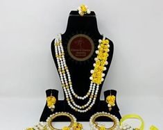 an assortment of yellow and white jewelry on display