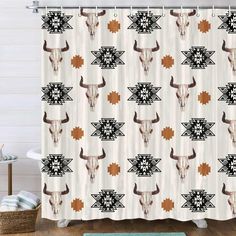 the shower curtain is decorated with longhorns and geometrical designs on it's side