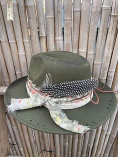 Decorated wide brimmed fedora hat will complement any outfit! With a western boho style, this hat can be for both casual and formal.  This hat has been burnt and hand stitched to give it a unique distressed appearance . Hand made hat-bands include a one of a kind design using an assortment of fabrics, premium leather and real feathers.  Please feel free to message me with any customization requests. These are quite literally completely customizable. One Size Fits MOST. 22 3/8 circumference inner Country Style Wide Brim Felt Hat For Beach, Vintage Wide Brim Fedora For Fall, Rustic Adjustable Felt Hat For Festival, Distressed Adjustable Hats For Country Events, Adjustable Distressed Hats For Country Events, Western Brimmed Fedora For Fall, Western Style Brimmed Fedora For Fall, Wide Brim Fedora For Western-themed Events, Western Wide Brim Fedora For Fall