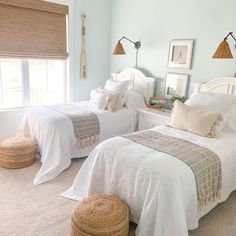 two beds in a bedroom with white linens