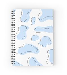 a spiral notebook with blue and white shapes