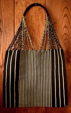 This unique handwoven market tote bag from Mexico was made on a traditional Maya loom- combining ancient weaving techniques with a modern design. It is a perfect gift, gift bag, or addition to your wardrobe. The beige and black stripes make this a bag that can be combined with many different outfits, and it looks great with a neutral outfit.  Spot clean with soap and water using cloth. Air dry only! Woven Tote Beach Bag For Market, Black Bohemian Crochet Bag Handwoven, Traditional Handwoven Shoulder Bag For Everyday, Rectangular Weaving Shoulder Bag For Daily Use, Eco-friendly Woven Beach Bag For Travel, Black Beach Bag With Braided Handles For Market, Black Beach Bag For Summer Market, Black Woven Square Beach Bag, Black Square Woven Beach Bag