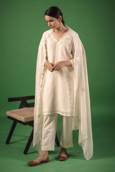 Ivory straight kurta in handloom chanderi base with tonal resham embroidery. Comes with pant and a sheer dupatta, highlighted with scallops and resham buttis. - Aza Fashions Traditional Slub Silk Kurta With Naqshi Details, Traditional Slub Silk Kurta With Naqshi, Traditional Naqshi Slub Silk Kurta, Chanderi Straight Kurta With Naqshi, Straight Chanderi Kurta With Naqshi Detail, Traditional Chanderi Palazzo Set With Naqshi, Off White Chanderi Palazzo Set With Sheer Dupatta, Traditional Naqshi Palazzo Set With Straight Kurta, Bohemian Lawn Suit With Sheer Dupatta And Straight Kurta